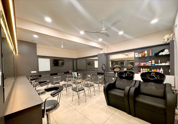 Training floor at MARK Academy with styling chairs and wash stations