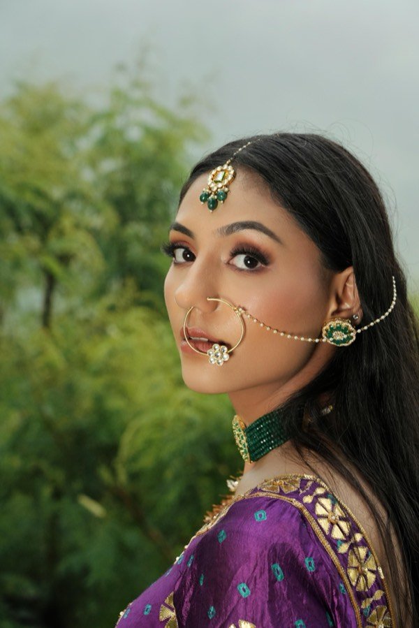 Bridal makeup with a violet lehenga and kundan jewellery