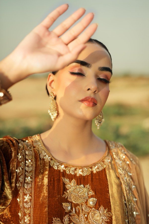 Sun-kissed editorial makeup with gold earrings