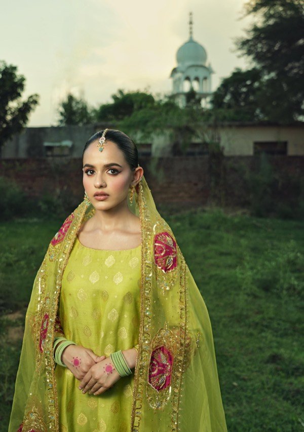 Traditional look with a green suit and embroidered dupatta