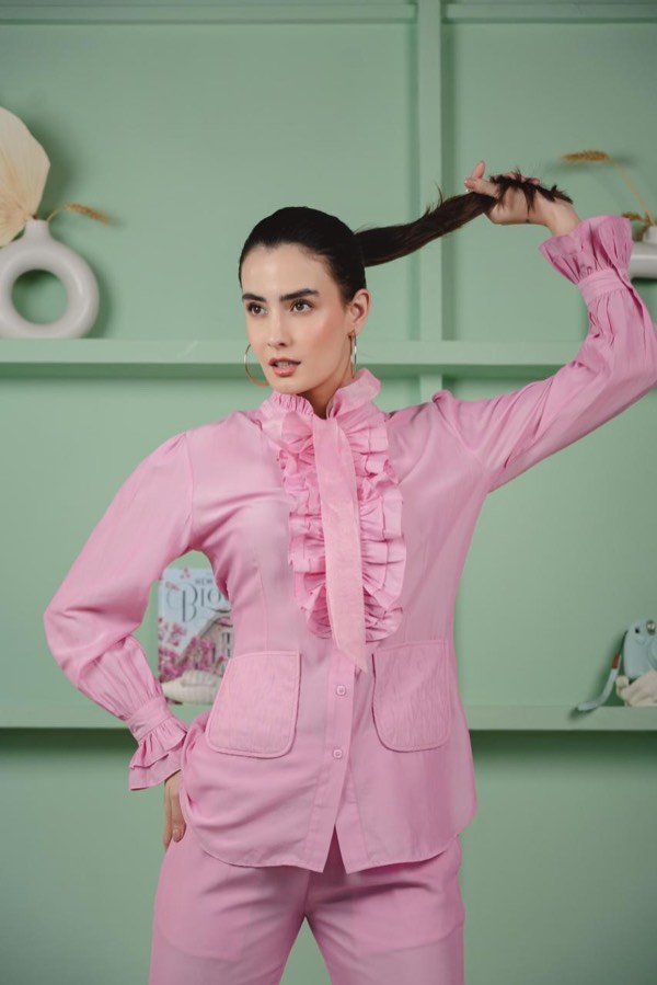 Editorial look with a pink ruffle shirt